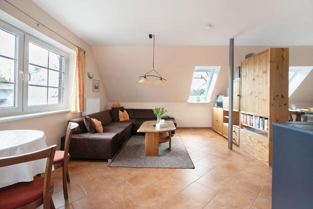 a living room with a couch and a table at Ferienwohnung Coni in Langballig