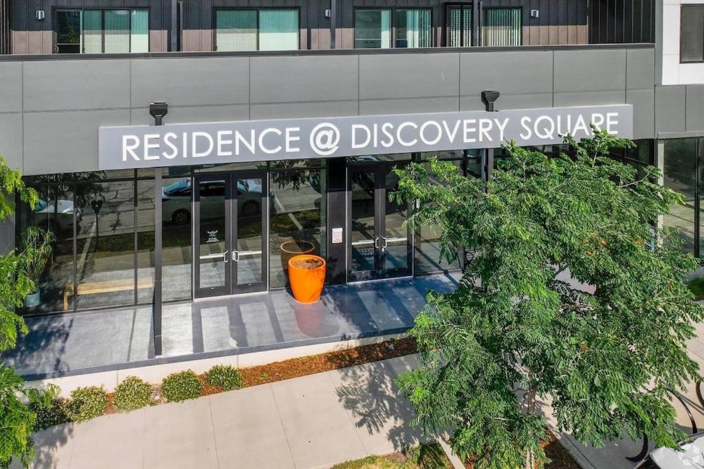 an office building with a sign for discovery square at Contemporary Living near Mayo in Rochester