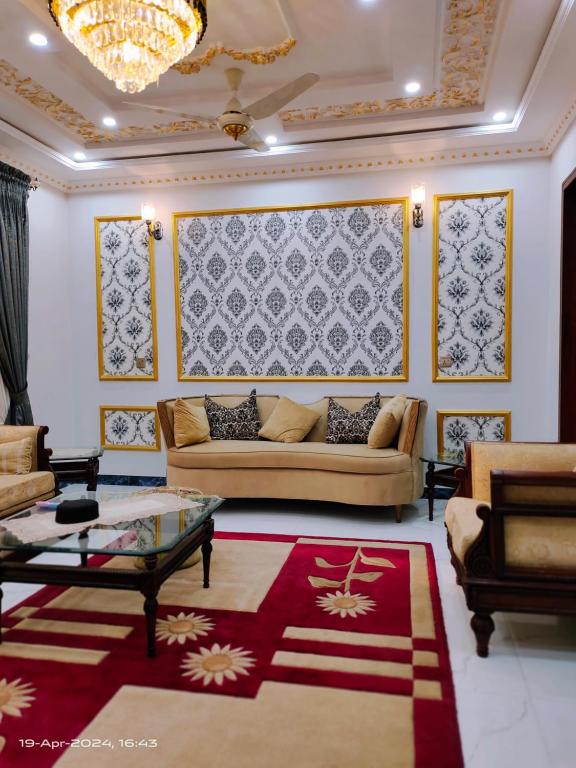 a living room with a couch and a table at VIP Luxury Room's in Lahore