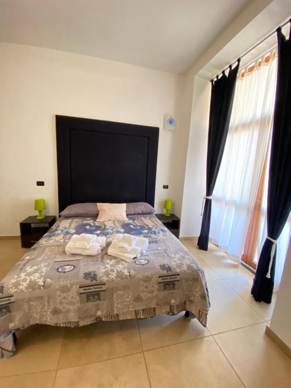 a bedroom with a large bed with a large headboard at Abruzzi 81 in Lecce