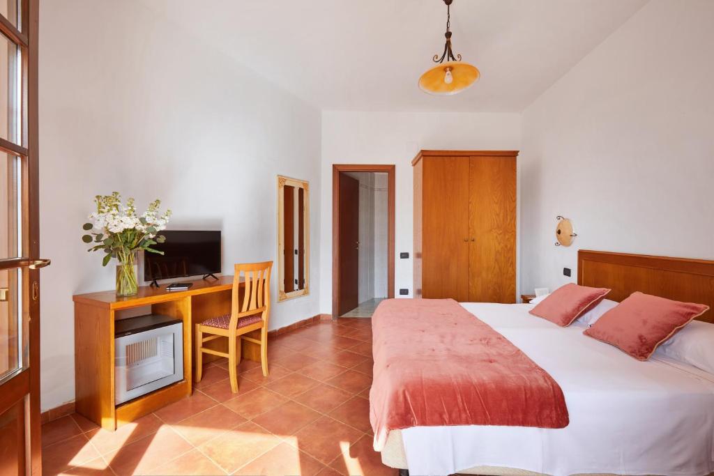 Postel nebo postele na pokoji v ubytování Hotel Fattoria Belvedere