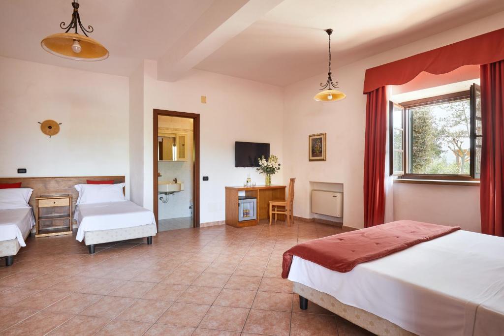 Postel nebo postele na pokoji v ubytování Hotel Fattoria Belvedere