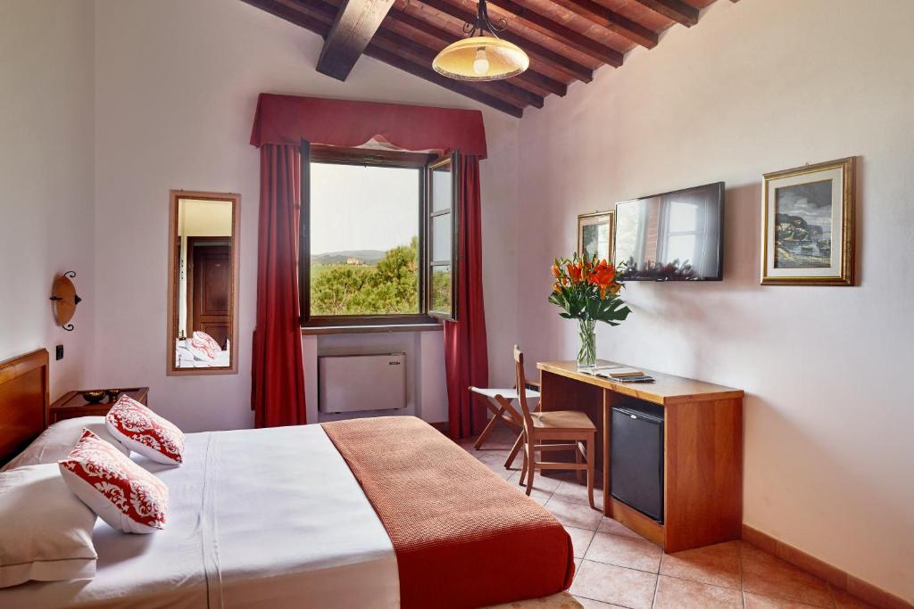 Postel nebo postele na pokoji v ubytování Hotel Fattoria Belvedere