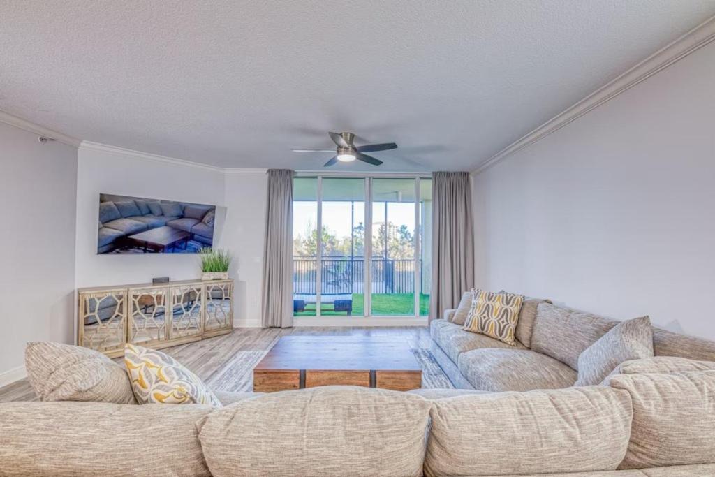 a living room with a couch and a table at Foxy Palmer Lost Key 205 in Perdido Key