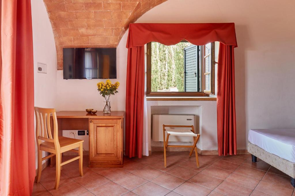 Postel nebo postele na pokoji v ubytování Hotel Fattoria Belvedere