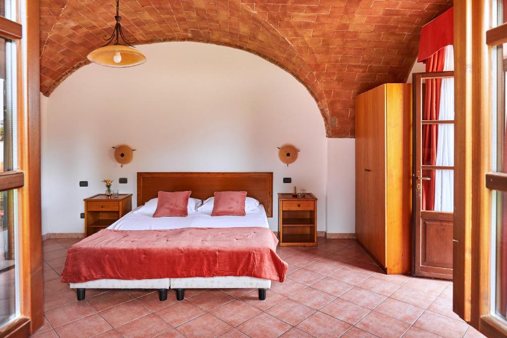 Postel nebo postele na pokoji v ubytování Hotel Fattoria Belvedere