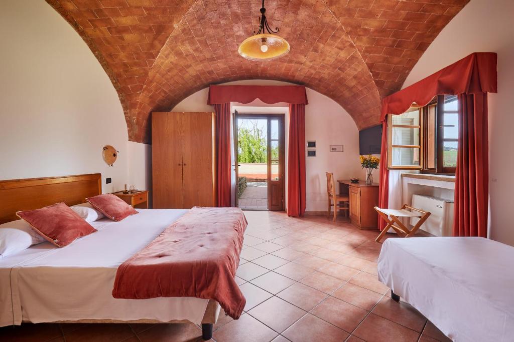 Postel nebo postele na pokoji v ubytování Hotel Fattoria Belvedere