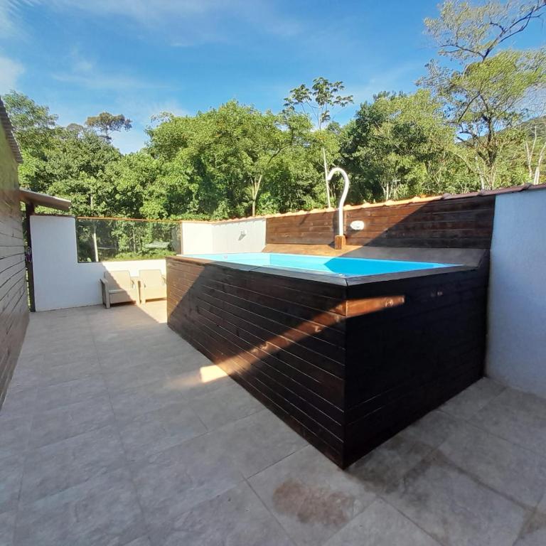 a kitchen with a sink on a patio at Chalé Ubatuba in Ubatuba