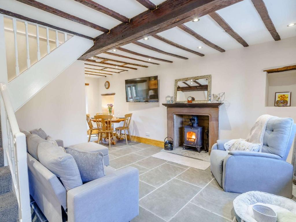 a living room with chairs and a fireplace at 2 Bed in Ulverston 83453 in Great Urswick