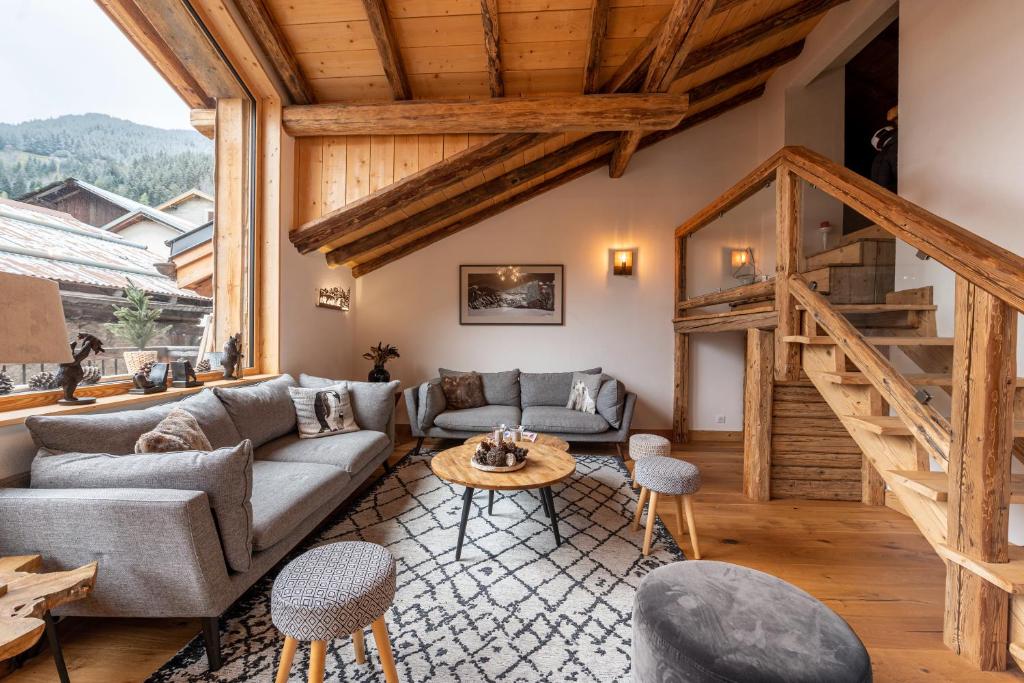a living room with a couch and a table at Chalet Alouette in Champagny-en-Vanoise