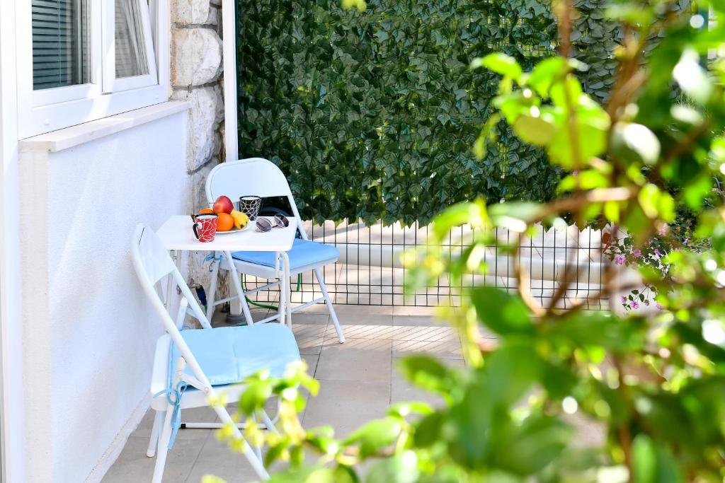 a table and a chair with fruit on it at Val Apartments in Dubrovnik