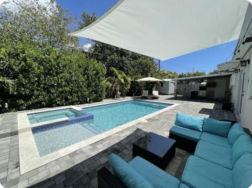 a swimming pool with blue lounge chairs and a swimming pool at Coral Terrace in Miami
