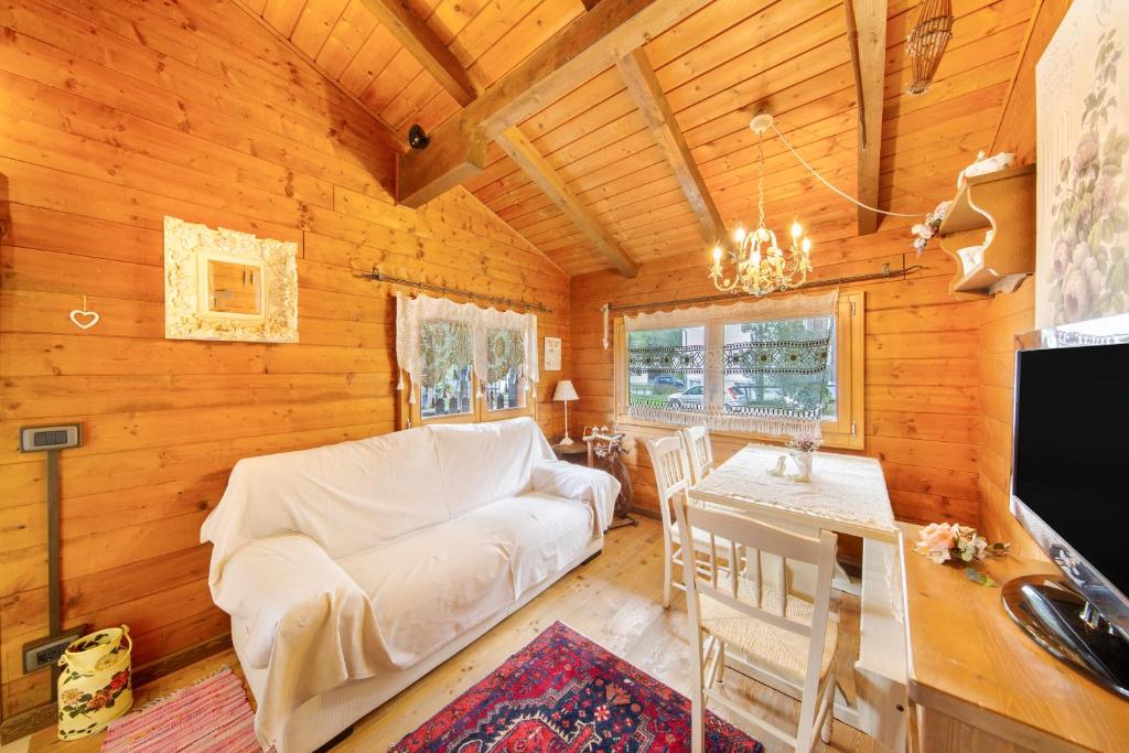 a living room with a couch and a table at Orserose Chalet 5 I Fus in Forno di Zoldo
