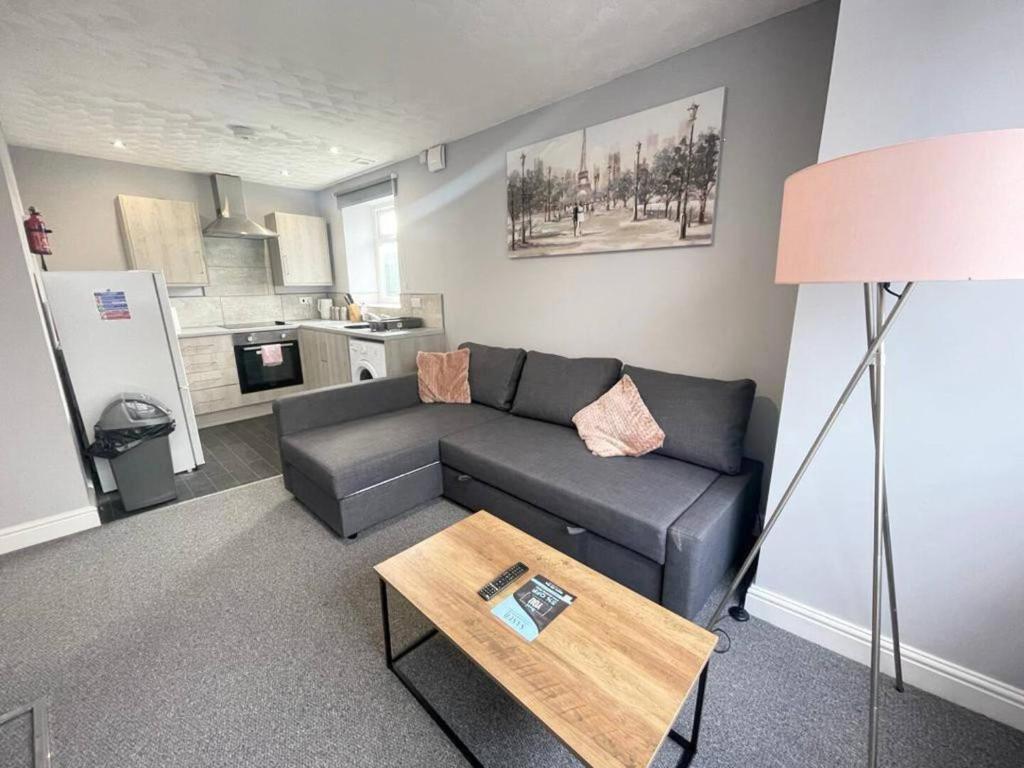 a living room with a couch and a table at Bloomfield Apartments in Blackpool
