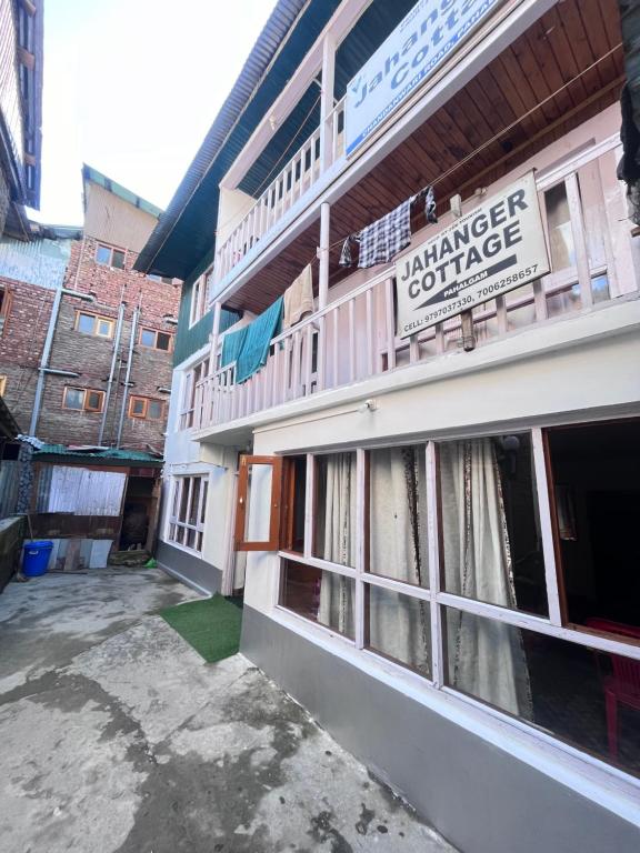 a building with a sign on the side of it at Jahangir Cottage Pahalgam in Pahalgām