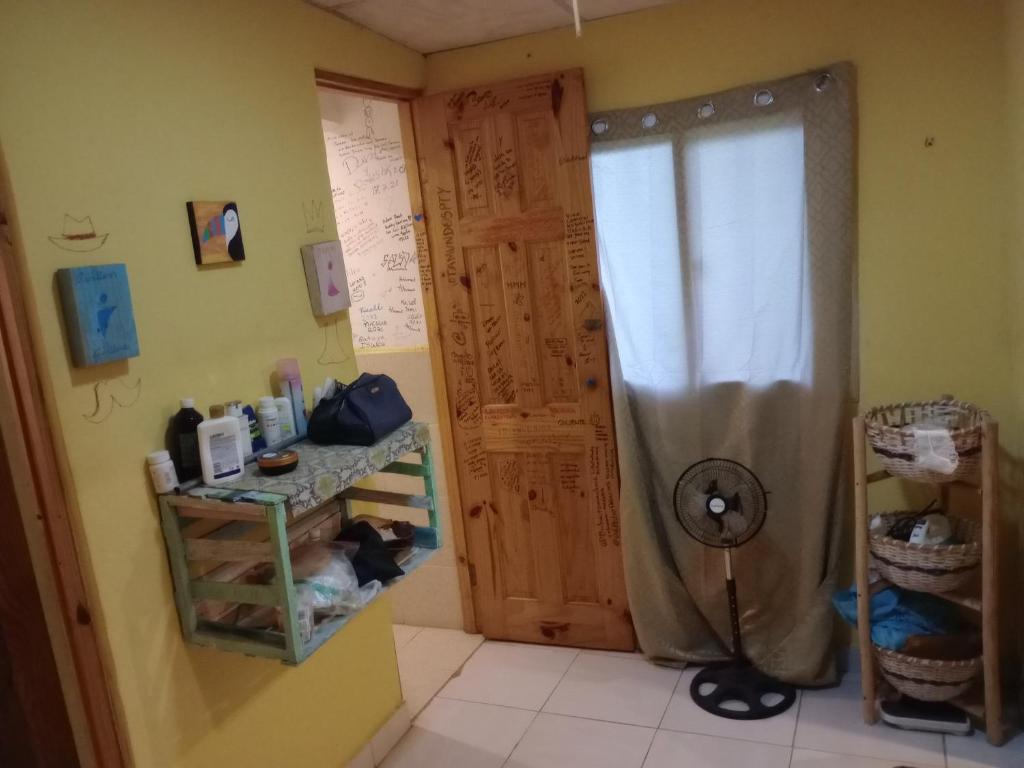 a bathroom with a shower with a wooden door at Taca Tucan in Cruce del Farallón