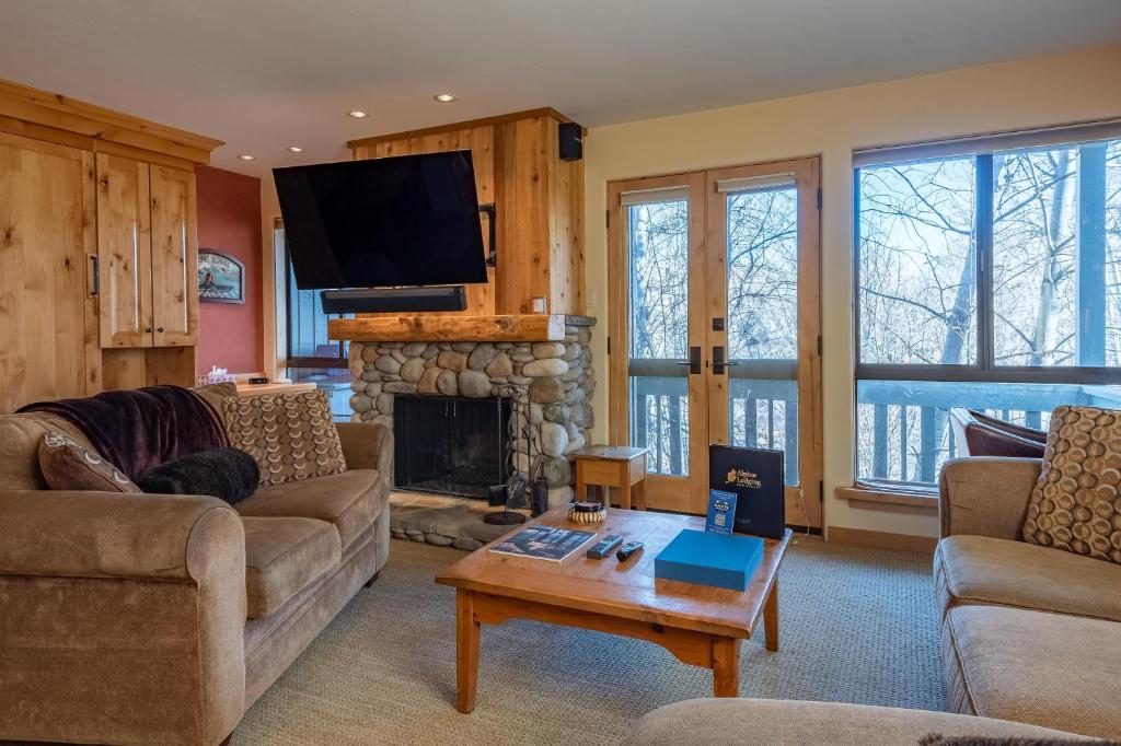 a living room with a couch and a fireplace at Cottonwood Condo 1474 in Sun Valley