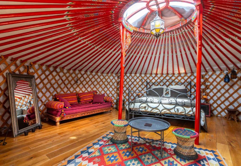 a room with a bed and a couch in a yurt at Valle de Oro in Villanueva de Algaidas