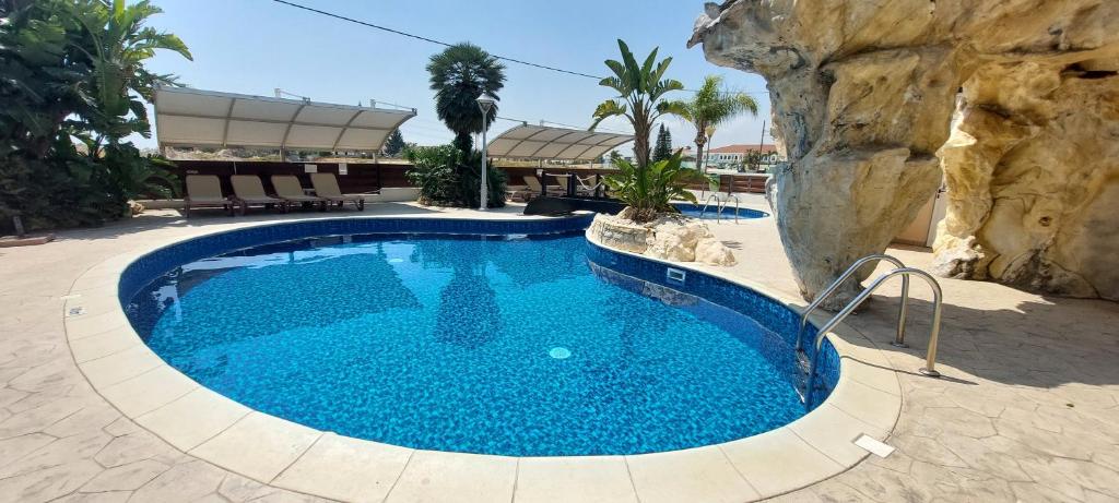 a large pool with blue water in a resort at Pyla Palms Resort - 1 bedroom in Pyla