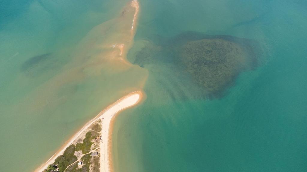 an aerial view of an island in the ocean at Pousada Refazenda in Corumbau