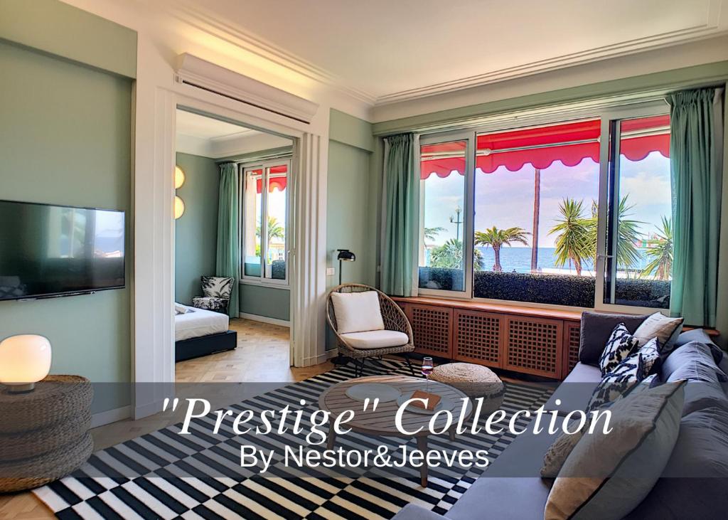 un salon avec un canapé et une grande fenêtre dans l'établissement Nestor&Jeeves - LAGOON PROMENADE - Central - Sea front, à Nice