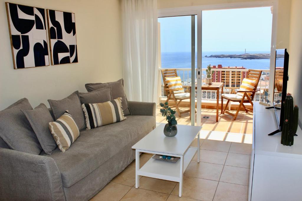 sala de estar con sofá y mesa en Amazing Ocean View Apartment en Poris de Abona