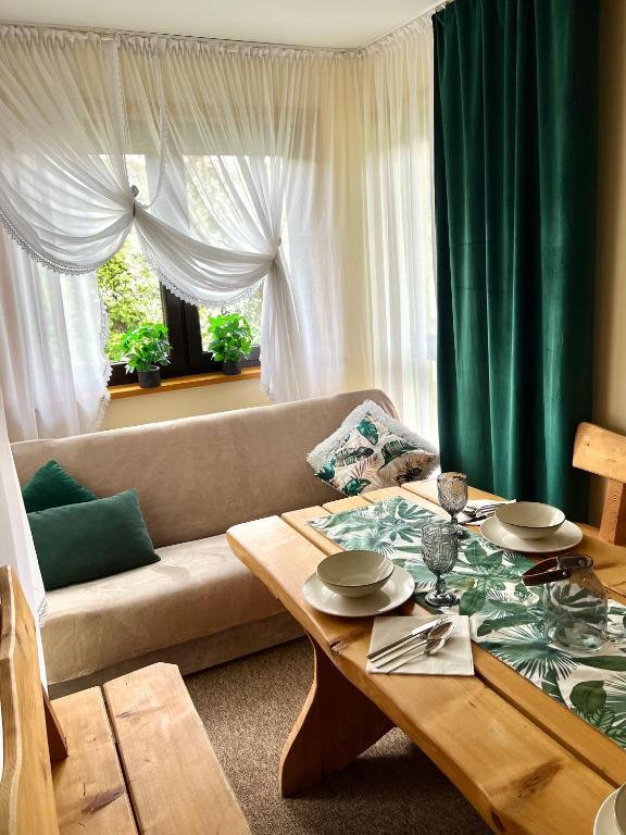 a living room with a couch and a table at AgroDomek Rzepiska in Rzepiska