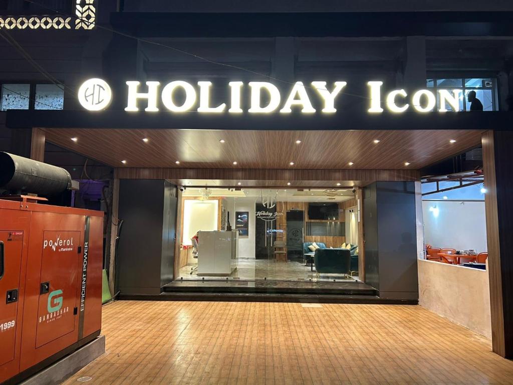 a store front with a holiday room sign on the wall at Hotel Holiday Icon in Dwarka