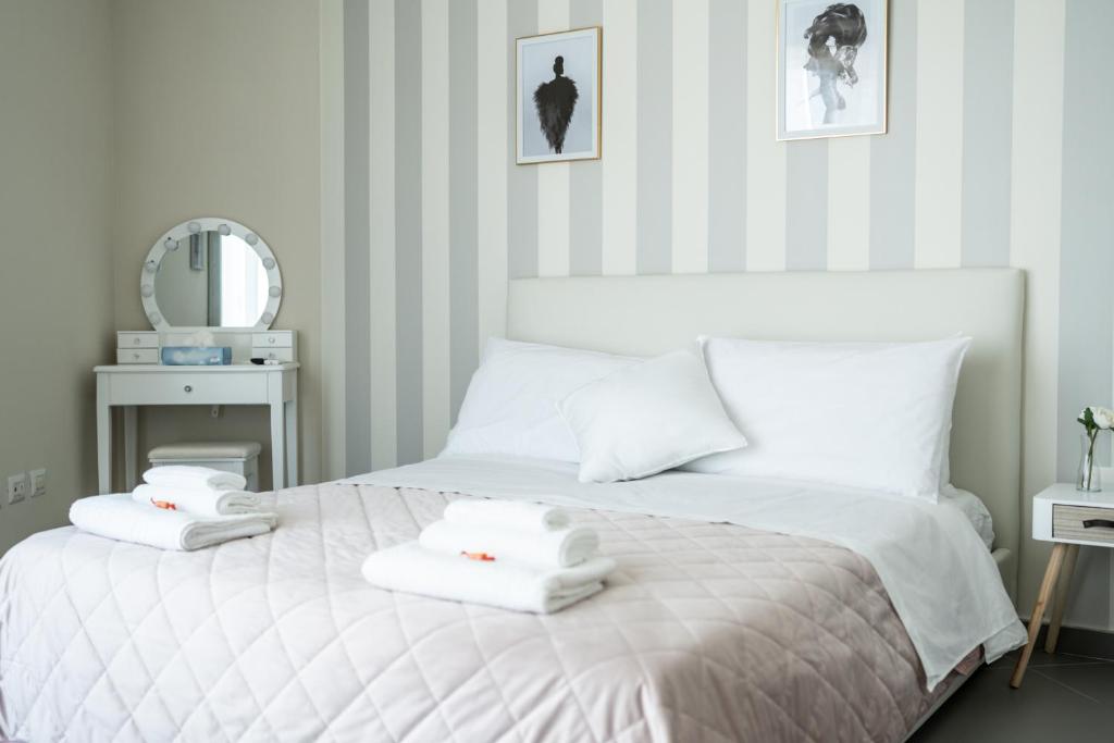 a bedroom with a white bed with towels on it at B&B Sweet Home - Cilento in Agropoli