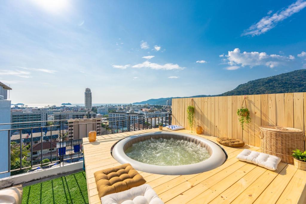 a hot tub on the deck of a building at Sky Wave Patong in Patong Beach