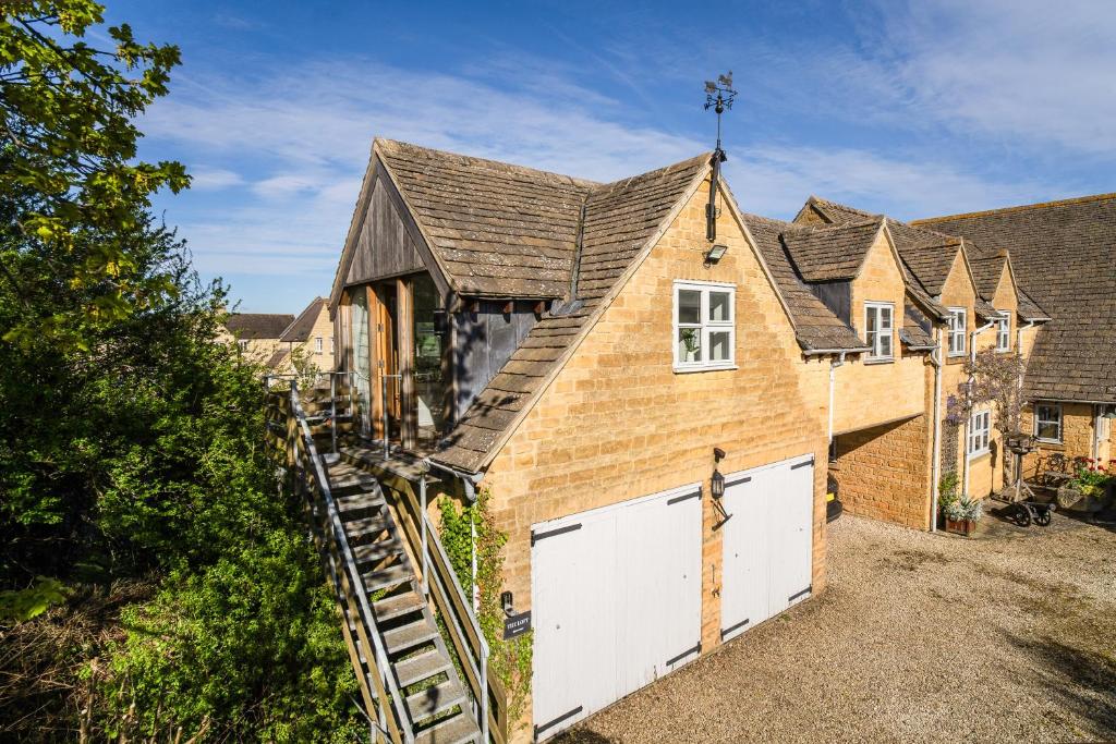 an exterior view of a house with a garage at The Loft in Mickleton