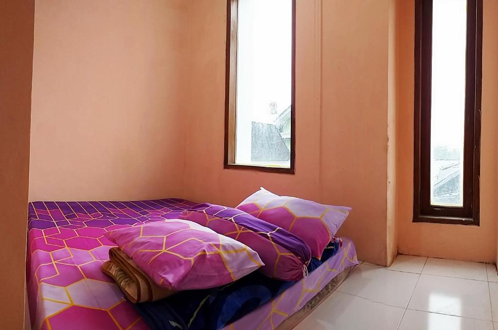 A bed or beds in a room at Ganendra Syari'ah Guesthouse