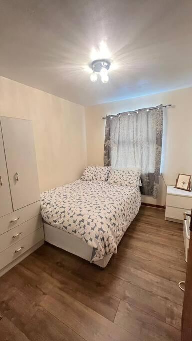 a small bedroom with a bed and a window at Apartment 6 in Drogheda