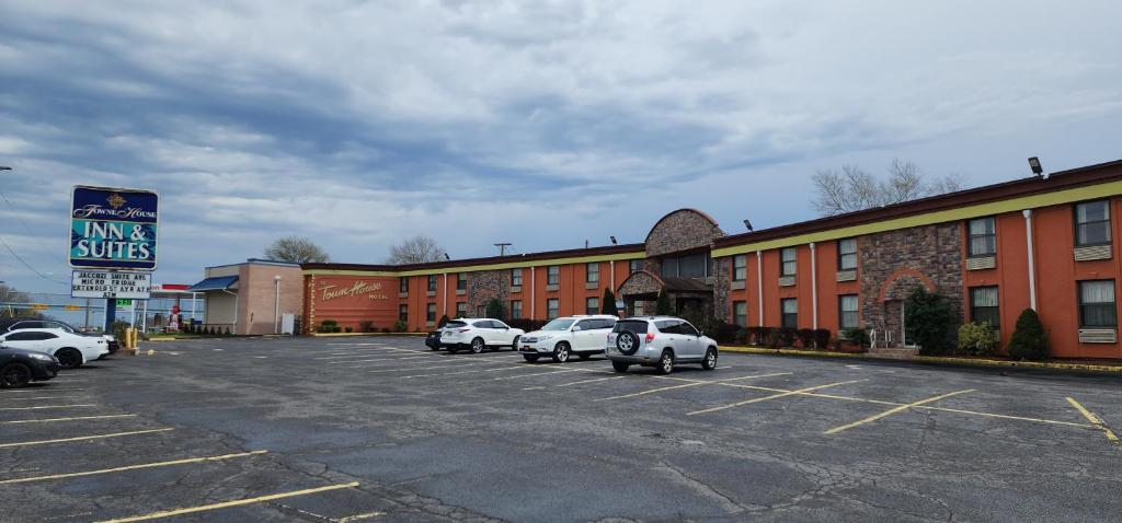 a parking lot with cars parked in front of a building at Town House Inn and Suites in Elmwood Park