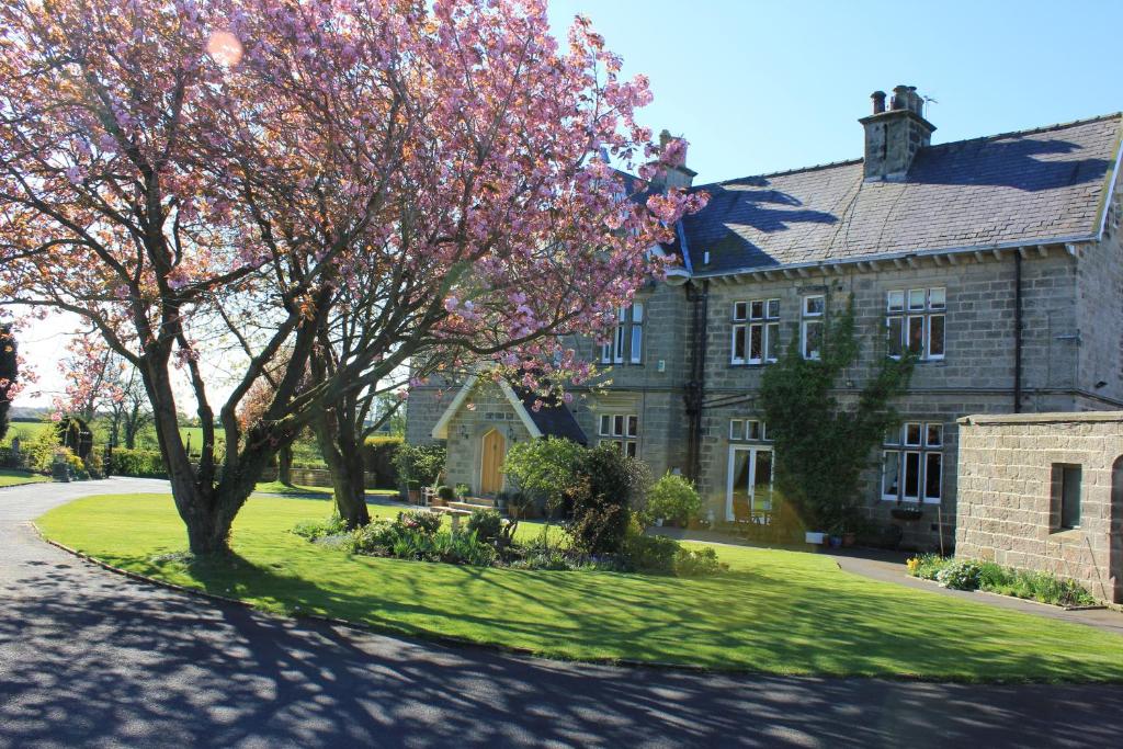 a house with a tree in front of it at Hazel Manor in Harrogate