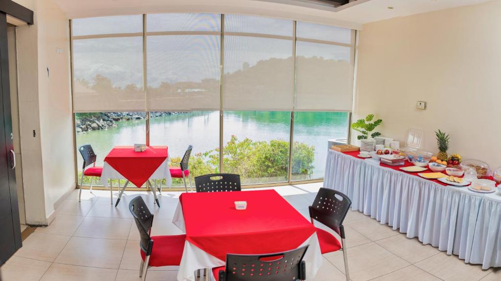 a dining room with a table and a large window at The Beach House in Panama City