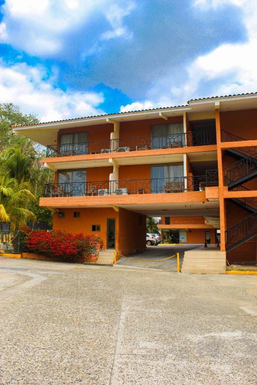 a large apartment building with balconies and a parking lot at The Beach House in Panama City