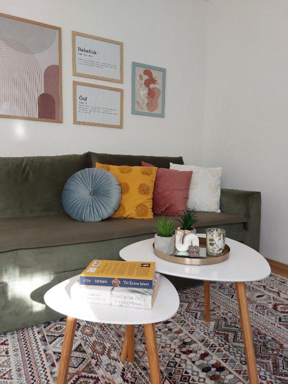 a living room with two tables and a couch at Kia Ora in Bihać
