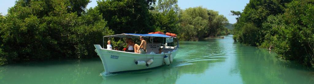 a group of people on a boat on a river at Acheron rooms in Preveza