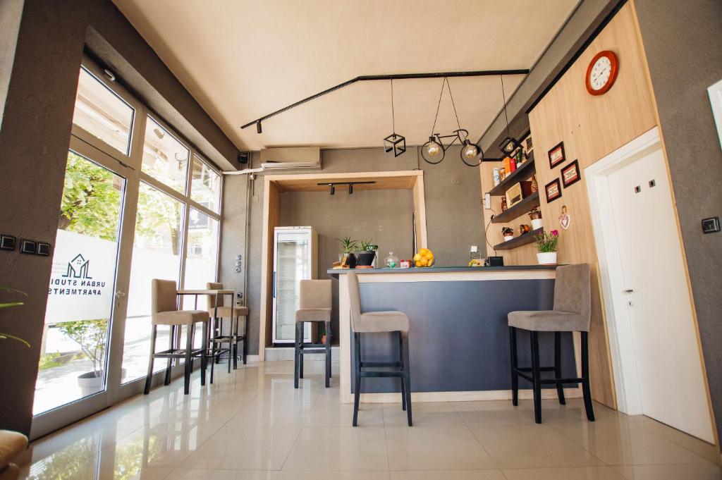 a kitchen and dining room with a bar with stools at Urban Studio Apartments in Strumica