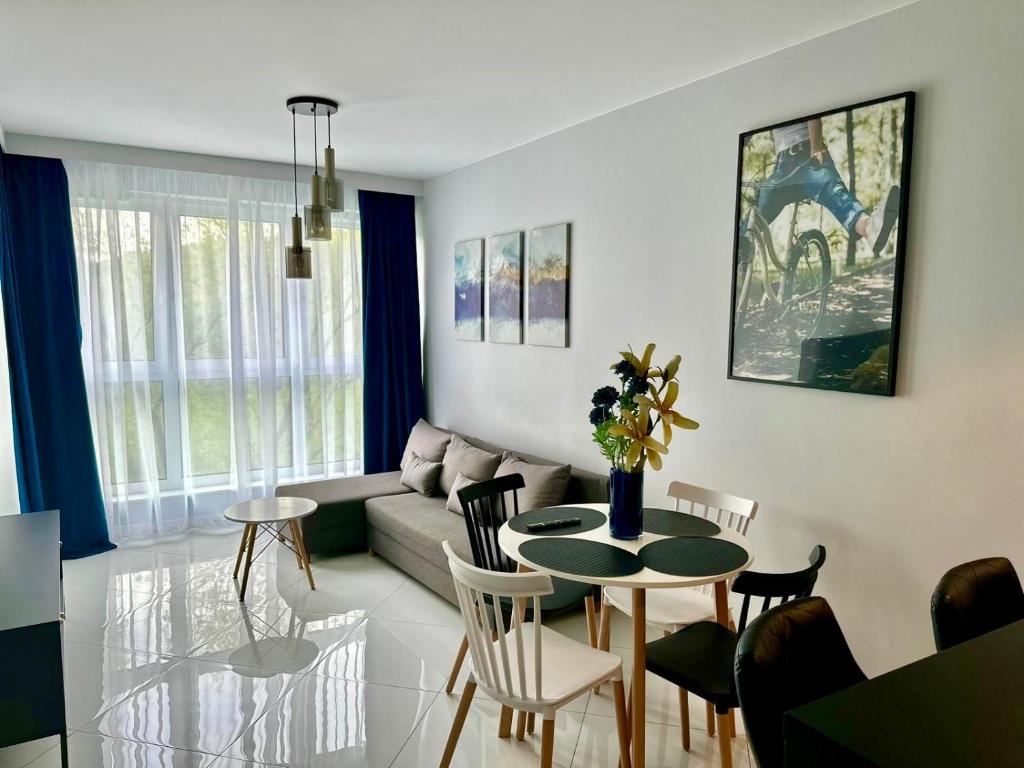 a living room with a table and a couch at Blisko Gór Szyndzielnia in Bielsko-Biała