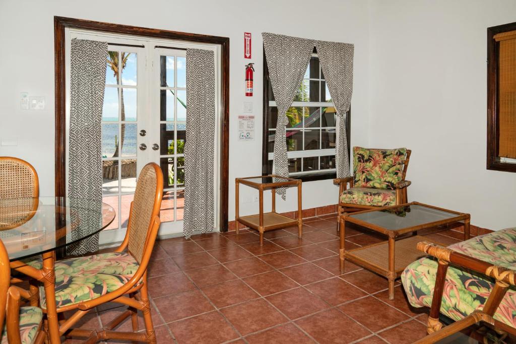 a living room with a glass table and chairs at X'tan Ha- The Waterfront in San Pedro