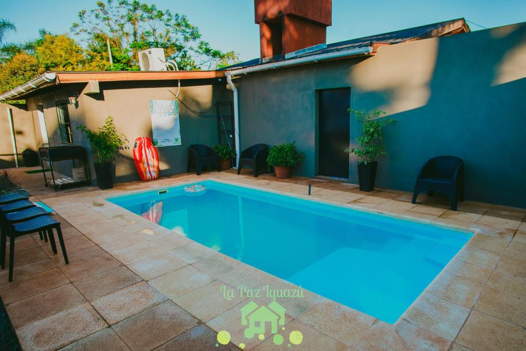 a swimming pool in the backyard of a house at La Paz Iguazú in Puerto Iguazú