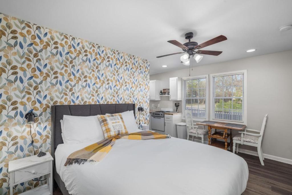 a bedroom with a large bed and a kitchen at Downtown Kimmswick Studio Newly Renovated 
