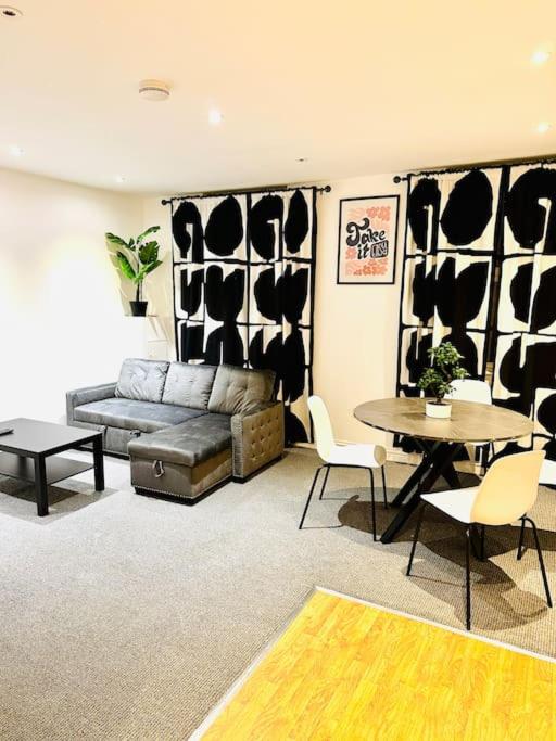 a living room with a couch and a table at Modern 2 bedroom Flat in Balham in London