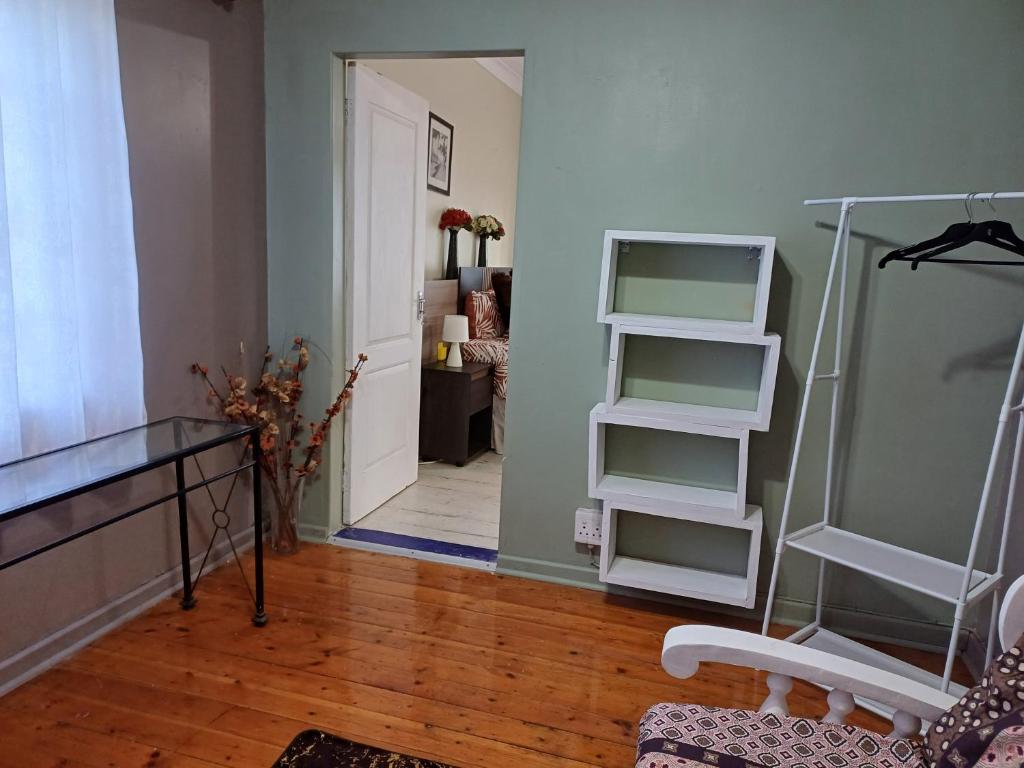 a room with a hallway with a door and shelves at 5 On Cologne in Germiston