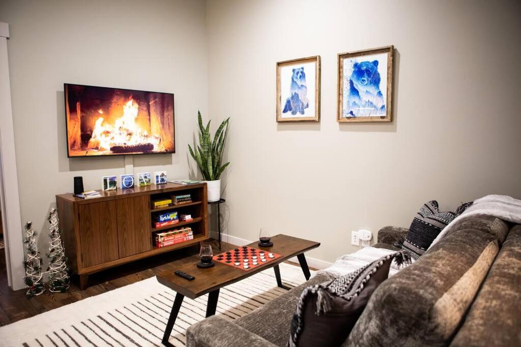 a living room with a couch and a tv and a chessboard at Downtown Whitefish awaits you at Central Ave Suite in Whitefish