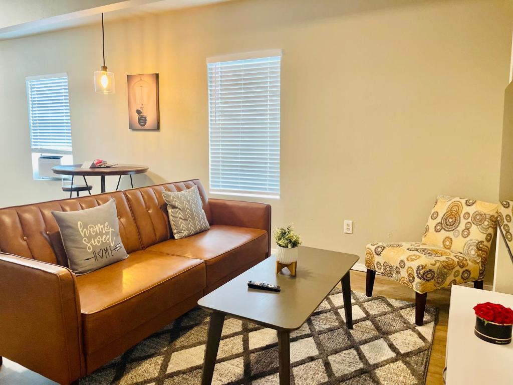 a living room with a couch and a chair at Cozy location in Midtown! in Houston