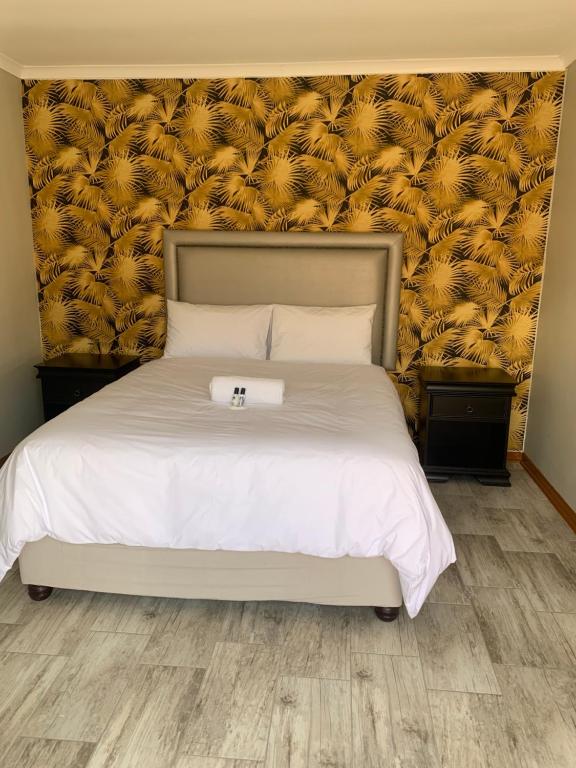 a bedroom with a bed with a large headboard at Grandview adventure and guesthouse in East London