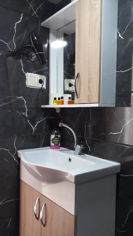 a bathroom with a white sink and a mirror at BACHOS HOTEL SULTANAHMET sea view terrace in Istanbul